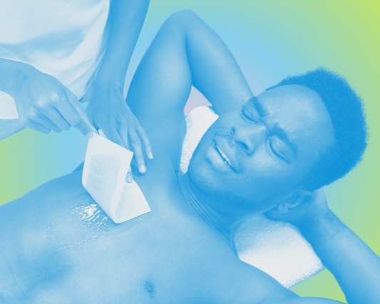 A Black man is lying on his back having his chest waxed